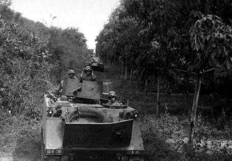 Tanks deploy between jungle and rubber plantations in Operation Cedar Falls during the Vietnam War.