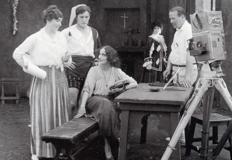 Black and white photograph of Lois Weber (left) directing Anna Pavlova and Douglas Gerrard on the set of The Dumb Girl of Portici (1916).